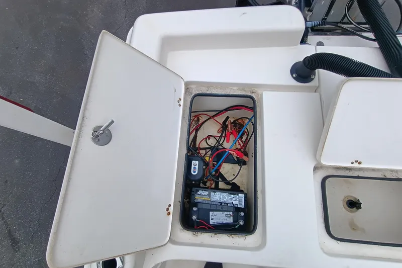 Slide: The Image of Open battery compartment of 2006 ShearWater Z2200 boat showing wiring and connections. - 56