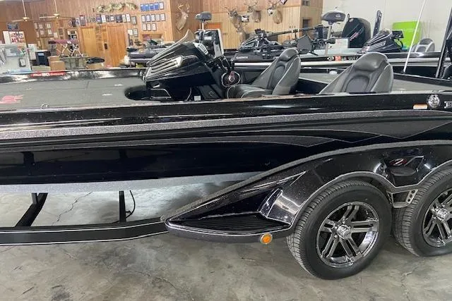 Slide: The Image of 2019 Ranger Z520C Carbon Comanche boat in showroom, black exterior, dual seats, trailer attached. - 3