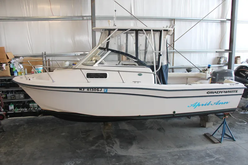 Slide: The Image of 2000 Grady-White Adventure 208 boat in storage, side view, with Yamaha engine. - 2