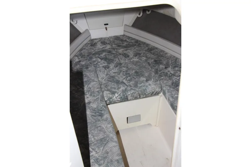 Slide: The Image of Interior cabin of 2000 Grady-White Adventure 208 boat with cushioned seating. - 5