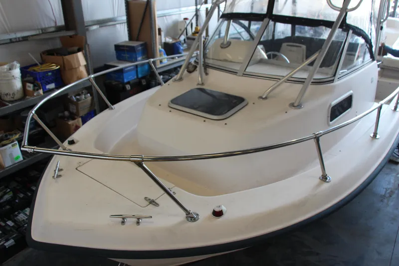 Slide: The Image of 2000 Grady-White Adventure 208 boat in storage, showcasing bow and cabin details. - 7