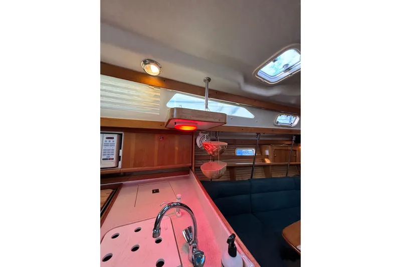 Slide: The Image of Interior of a 1999 Catalina 380 sailboat with cozy seating and nautical decor. - 12