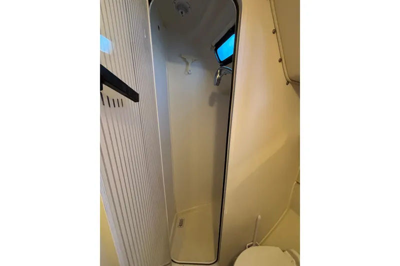 Slide: The Image of 1999 Catalina 380 yacht interior with navigation panel and wooden desk. - 15