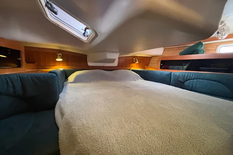 Slide: The Image of Interior of a 1999 Catalina 380 sailboat with cozy seating and dining area. - 17