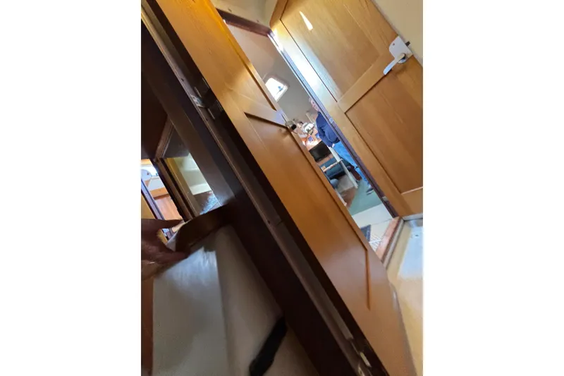 Slide: The Image of Interior of a 1999 Catalina 380 yacht kitchen with wood cabinetry and modern appliances. - 22