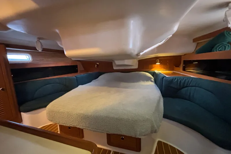 Slide: The Image of Cozy cabin interior of 1999 Catalina 380 sailboat with plush seating and ambient lighting. - 31