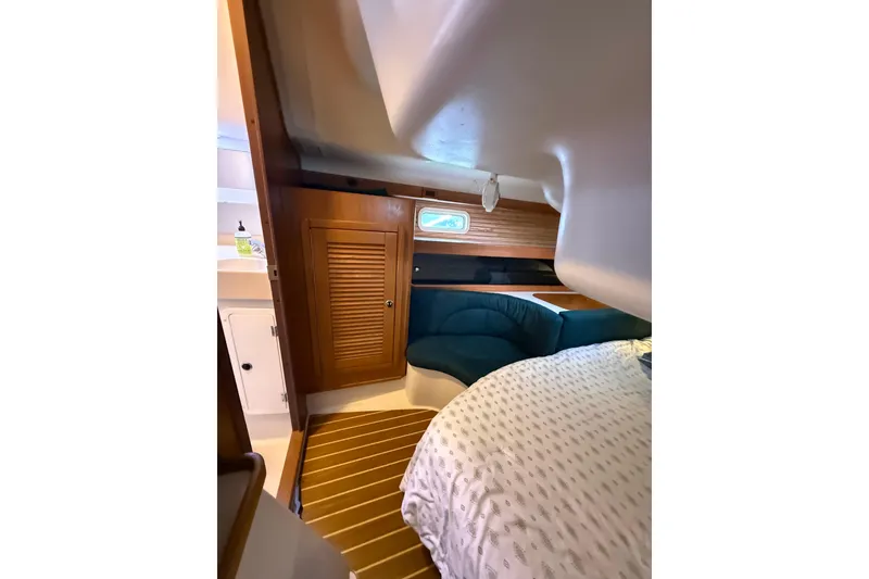 Slide: The Image of Interior of a 1999 Catalina 380 sailboat, featuring cozy cabin and wooden accents. - 32
