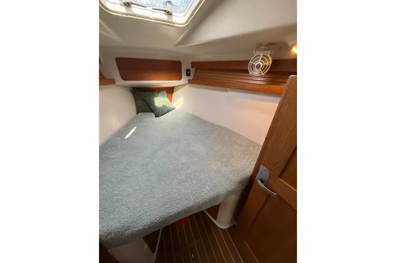 Slide: The Image of Cozy cabin interior of 1999 Catalina 380 sailboat with bed and wooden accents. - 36