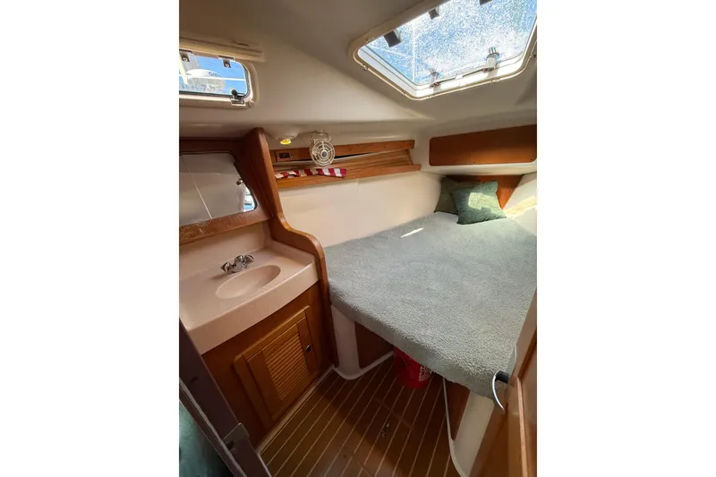 Slide: The Image of Cozy cabin interior of 1999 Catalina 380 sailboat with bed and sink. - 37
