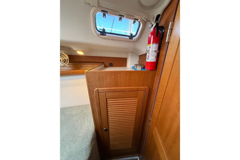 Slide: The Image of Interior of 1999 Catalina 380 sailboat with wooden cabinet and fire extinguisher. - 39