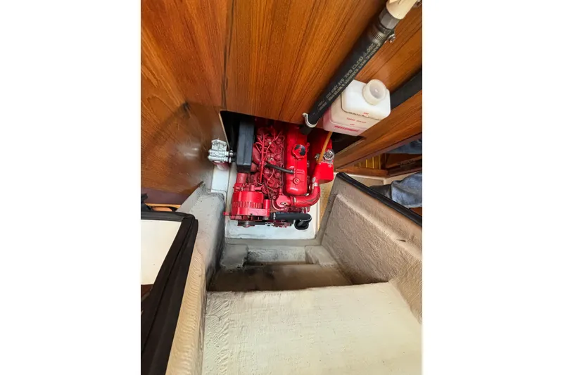 Slide: The Image of Engine compartment of a 1999 Catalina 380 sailboat, featuring a red engine. - 45