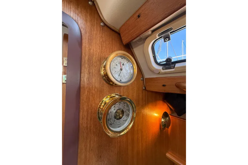 Slide: The Image of Brass instruments on 1999 Catalina 380 yacht interior, featuring clock and barometer. - 47