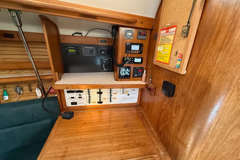 Slide: The Image of Navigation and control panel inside a 1999 Catalina 380 sailboat cabin. - 52