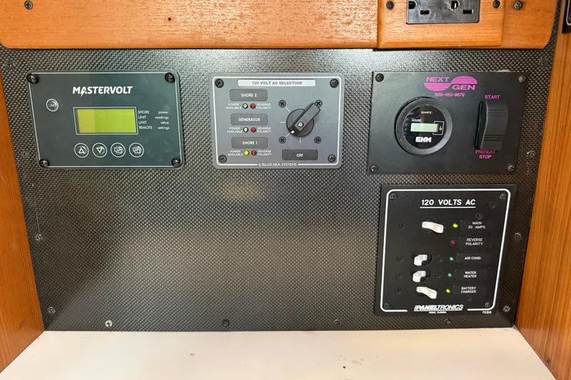 Slide: The Image of Electrical control panel on a 1999 Catalina 380 sailboat, featuring Mastervolt and Paneltronics systems. - 54