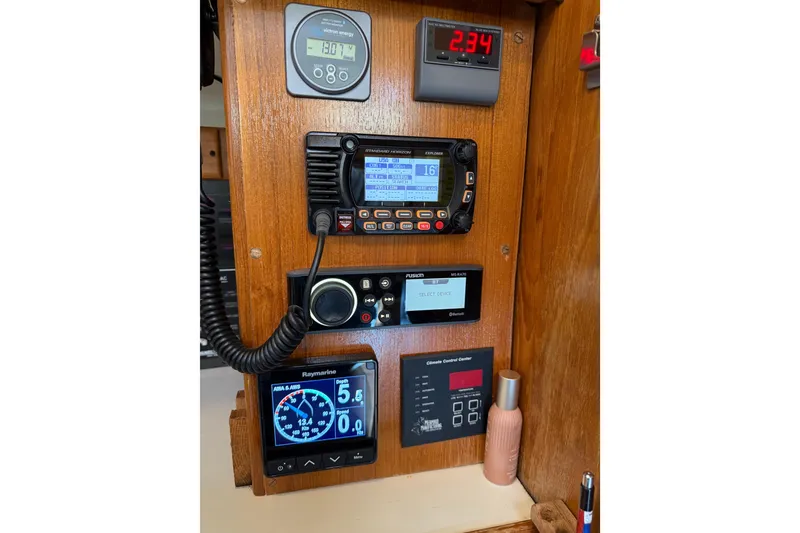 Slide: The Image of Control panel of a 1999 Catalina 380 sailboat with various electronic displays. - 56