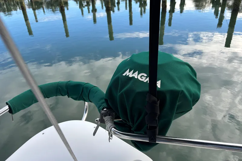 Slide: The Image of Green-covered Magma grill on 1999 Catalina 380 sailboat, reflecting on calm water. - 6