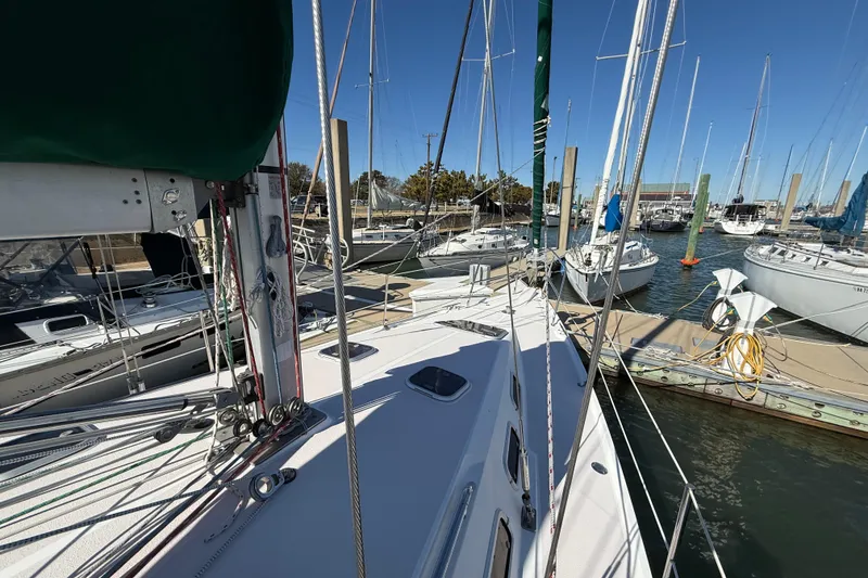 Slide: The Image of Sailboat docked in marina, Catalina 380, 1999 model, surrounded by other boats. - 62