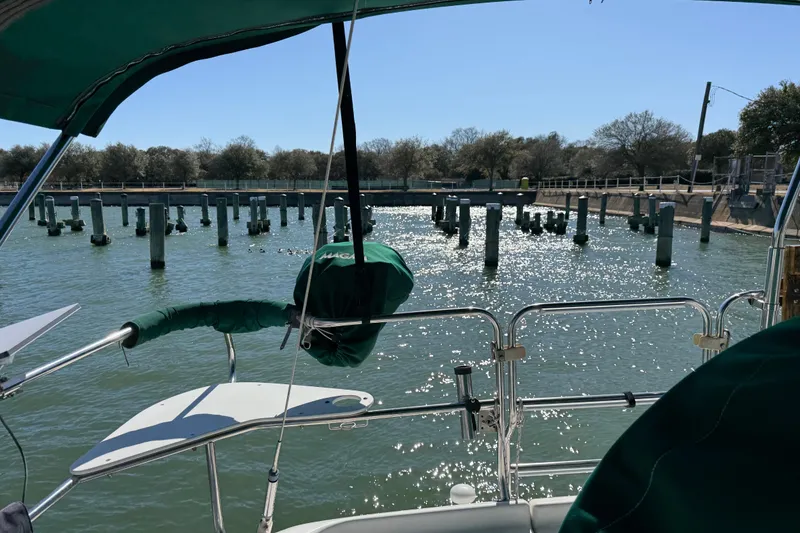 Slide: The Image of Sailing on a 1999 Catalina 380, overlooking a sparkling marina with pilings. - 66