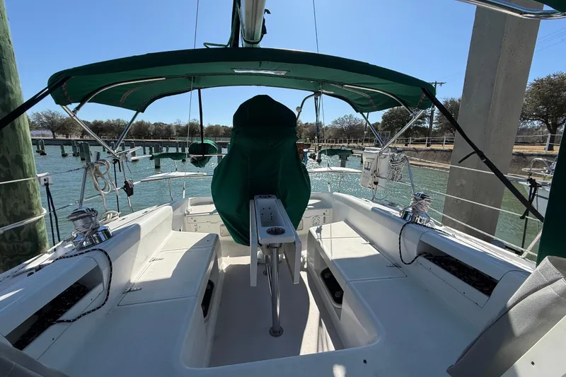 Slide: The Image of 1999 Catalina 380 sailboat cockpit with green canopy, docked at marina. - 67