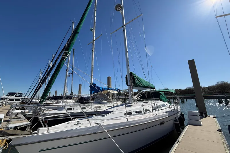Slide: The Image of 1999 Catalina 380 sailboat docked under clear blue sky. - 69