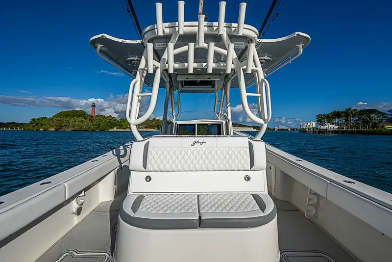 Slide: The Image of 2011 Yellowfin 39 Offshore boat interior with seating, ocean view, and clear blue sky. - 20