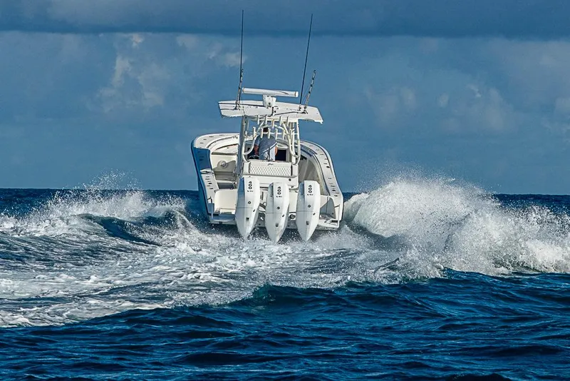 Slide: The Image of 2011 Yellowfin 39 Offshore boat navigating ocean waves, rear view. - 35