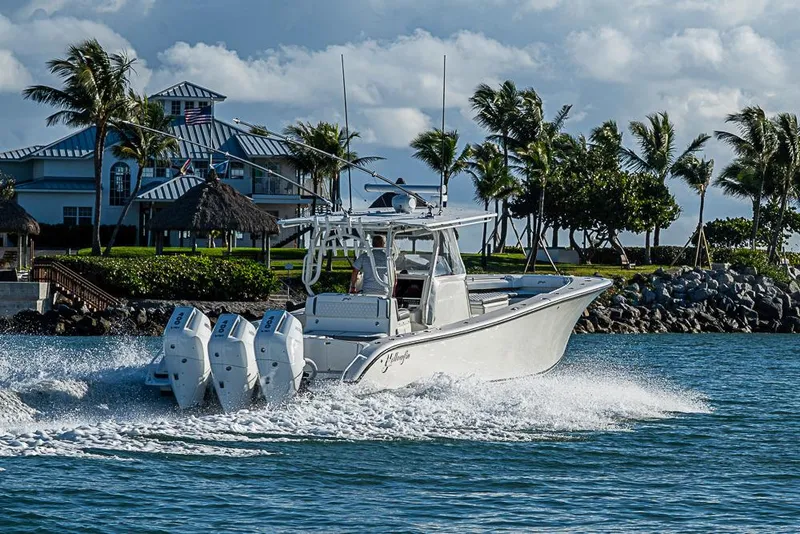 Slide: The Image of 2011 Yellowfin 39 Offshore boat cruising near tropical shoreline with palm trees. - 33