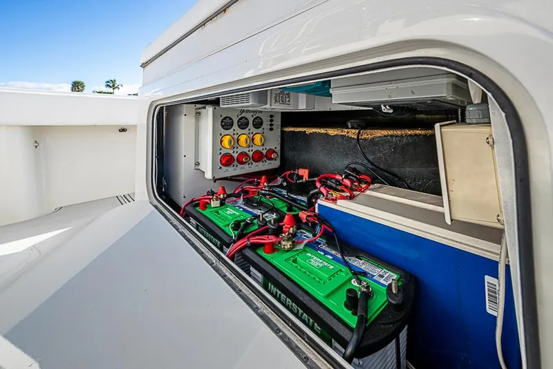 Slide: The Image of 2011 Yellowfin 39 Offshore boat battery compartment with wiring and control panel. - 16