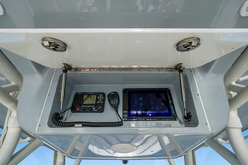 Slide: The Image of 2011 Yellowfin 39 Offshore boat console with radio and navigation display. - 19