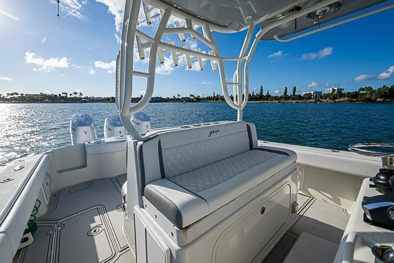Slide: The Image of 2011 Yellowfin 39 Offshore boat interior with seating, ocean view, and clear sky. - 15