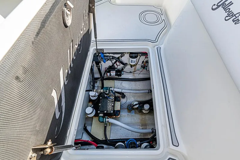 Slide: The Image of 2011 Yellowfin 39 Offshore boat interior showing open hatch with visible wiring and components. - 26