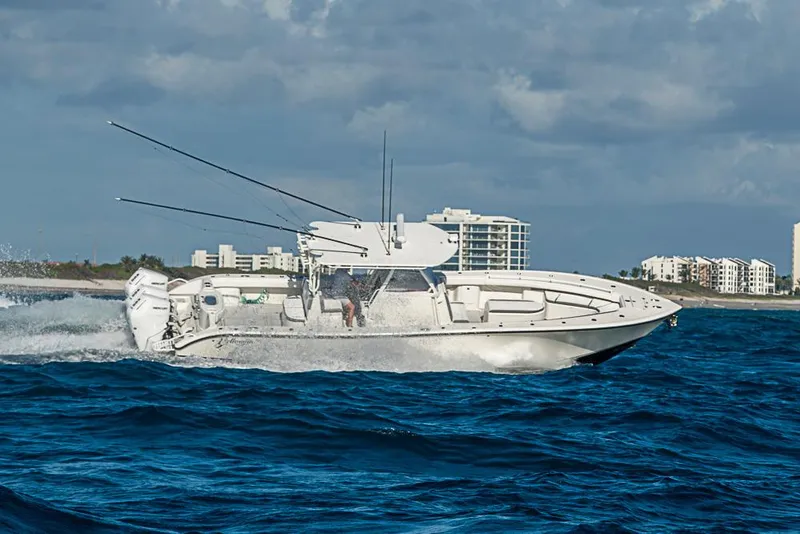 Slide: The Image of 2011 Yellowfin 39 Offshore boat cruising on ocean near coastal buildings. - 31