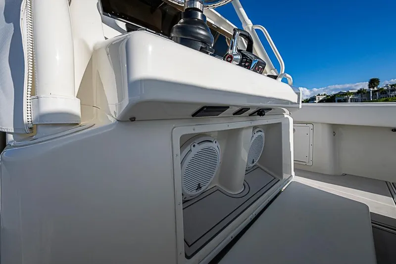 Slide: The Image of 2011 Yellowfin 39 Offshore boat console with speakers and controls, under clear blue sky. - 21