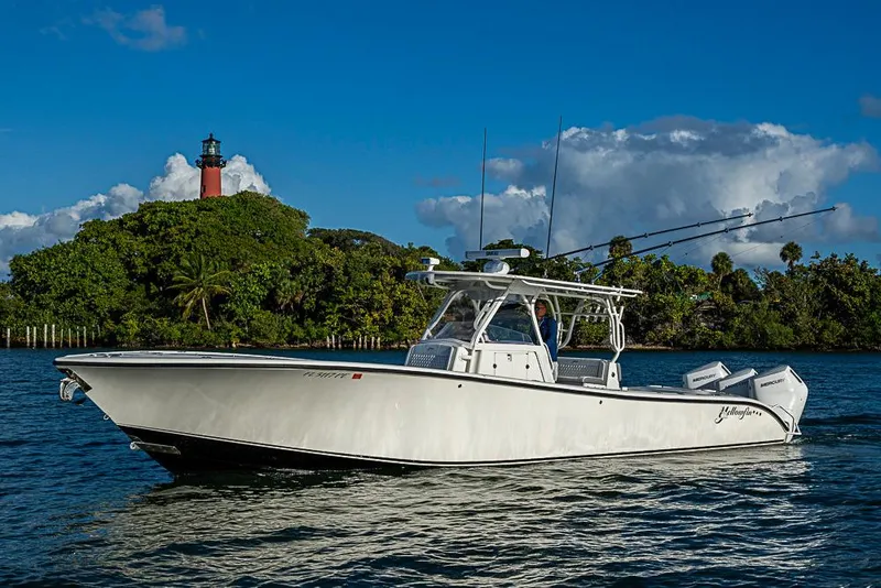 The Image of 2011 Yellowfin 39 Offshore boat cruising near a lush island with a lighthouse. - 0
