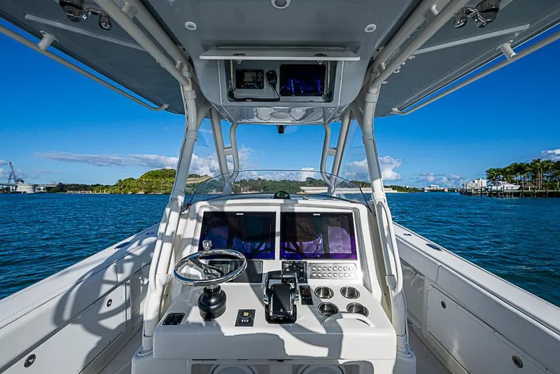 Slide: The Image of 2011 Yellowfin 39 Offshore boat dashboard with ocean view and clear blue sky. - 18