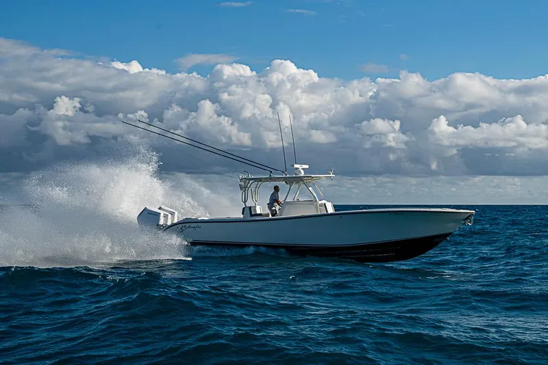 Slide: The Image of 2011 Yellowfin 39 Offshore boat navigating ocean waves under cloudy sky. - 34