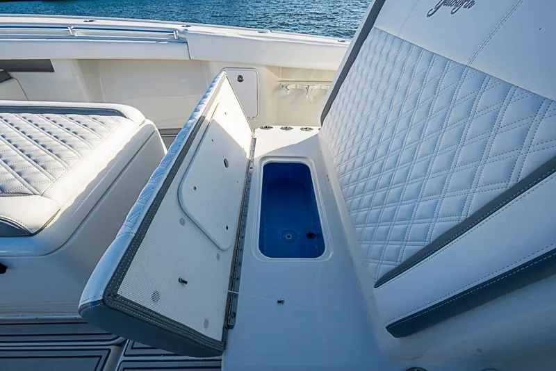 Slide: The Image of 2011 Yellowfin 39 Offshore boat with open storage compartment and quilted seating. - 13