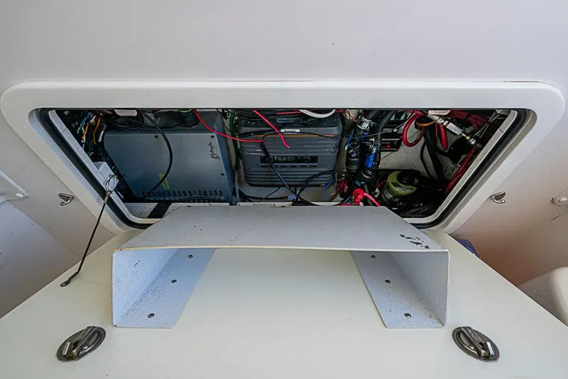 Slide: The Image of 2011 Yellowfin 39 Offshore boat electrical compartment with wiring and components. - 28