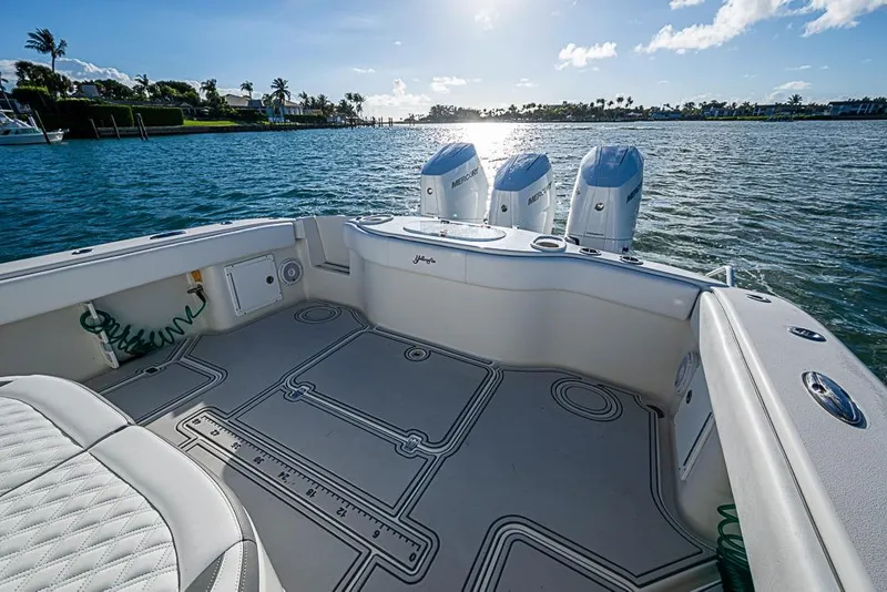 Slide: The Image of 2011 Yellowfin 39 Offshore boat with triple Mercury engines on a sunny day. - 23