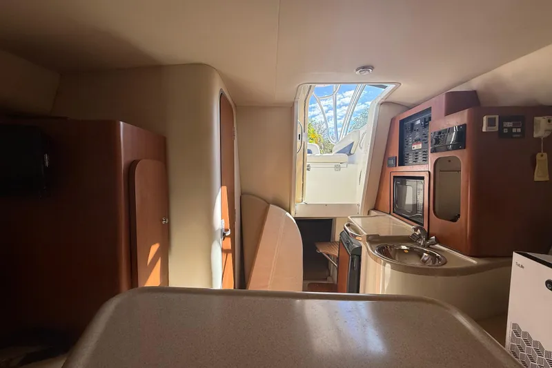 Slide: The Image of Interior of 2007 Hydra-Sports Vector 2900 VX boat, featuring kitchenette and cabin amenities. - 119
