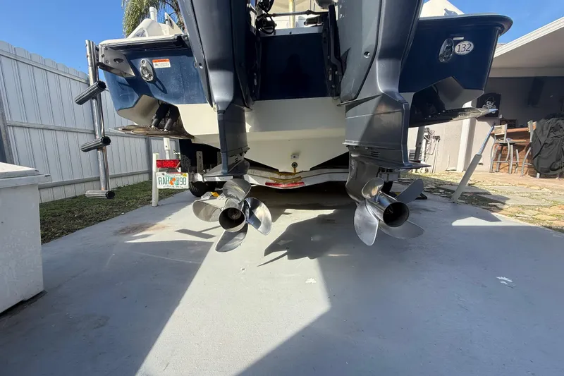 Slide: The Image of 2007 Hydra-Sports Vector 2900 VX boat with dual outboard motors in a driveway. - 12