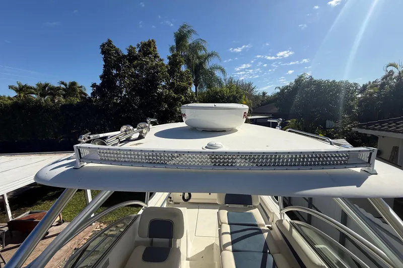 Slide: The Image of 2007 Hydra-Sports Vector 2900 VX boat with rooftop equipment, surrounded by lush greenery. - 149