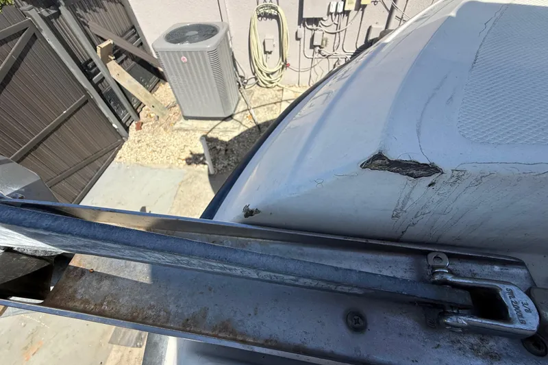 Slide: The Image of 2007 Hydra-Sports Vector 2900 VX with visible hull damage near metal railing. - 154