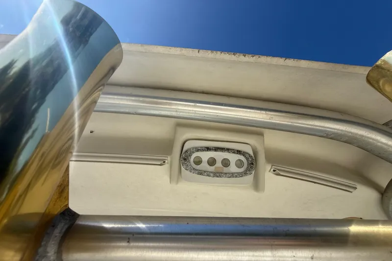 Slide: The Image of 2007 Hydra-Sports Vector 2900 VX boat detail with metal and fiberglass components under clear sky. - 169