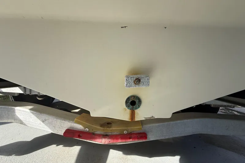 Slide: The Image of 2007 Hydra-Sports Vector 2900 VX boat hull on trailer, showing drain plug area. - 27