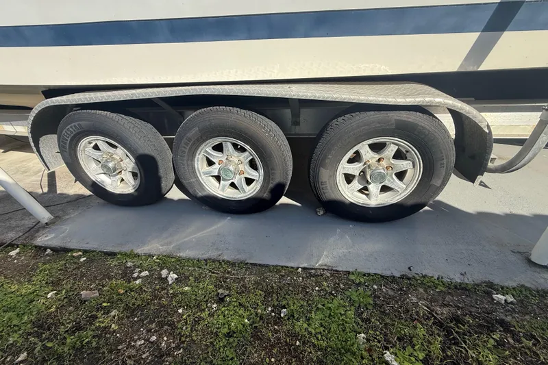 Slide: The Image of Triple-axle trailer for 2007 Hydra-Sports Vector 2900 VX boat, parked on concrete. - 40