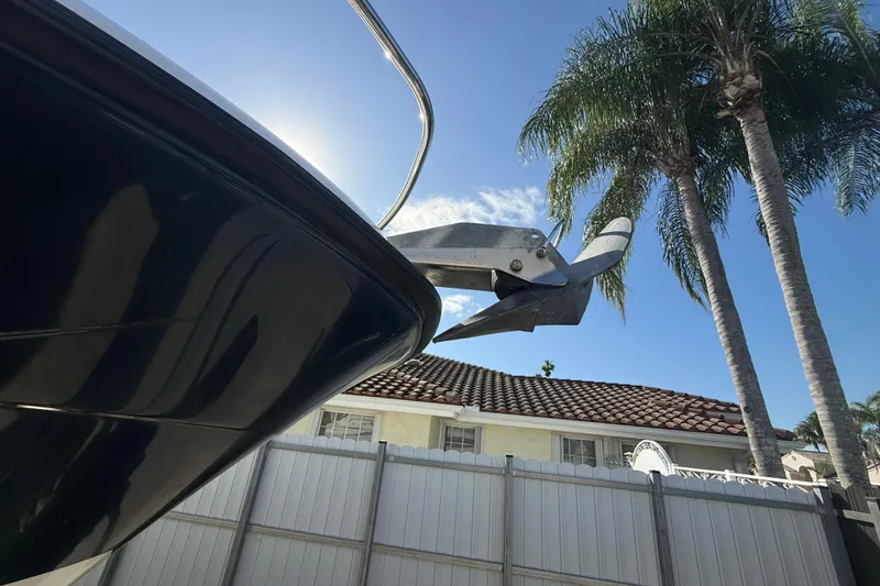 Slide: The Image of 2007 Hydra-Sports Vector 2900 VX boat with anchor, palm trees, and blue sky background. - 41