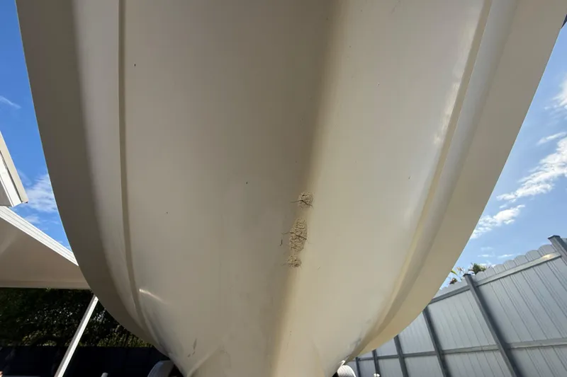 Slide: The Image of 2007 Hydra-Sports Vector 2900 VX boat hull with visible scratches, outdoor setting. - 50