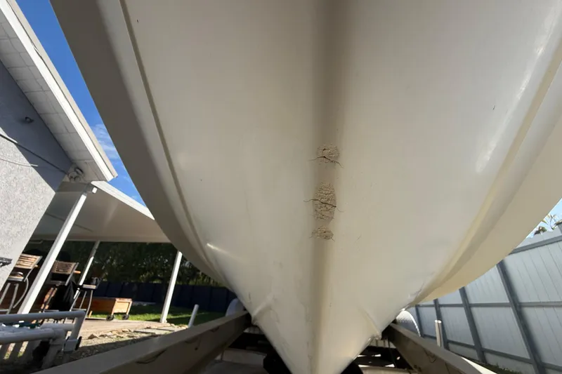 Slide: The Image of 2007 Hydra-Sports Vector 2900 VX boat hull with visible damage, parked on a trailer. - 52