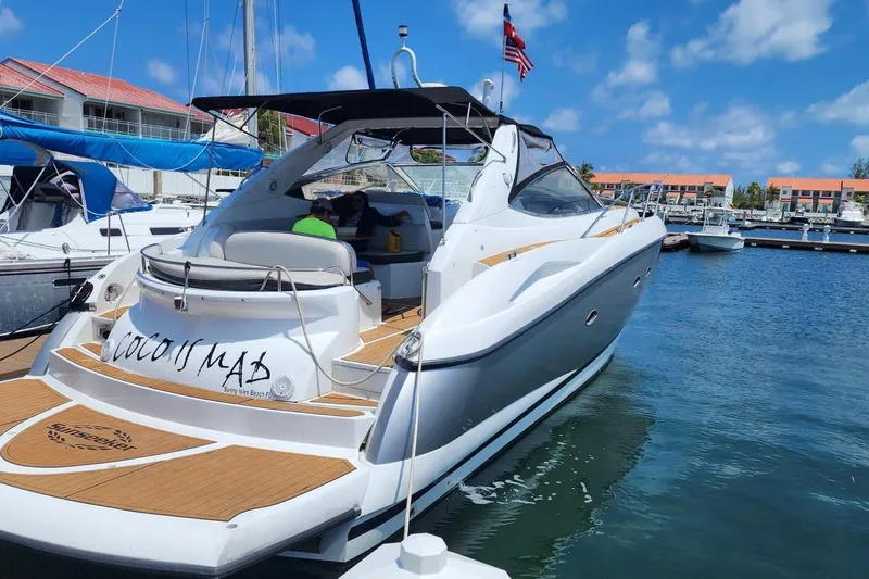 The Image of 2006 Sunseeker Portofino 47 yacht docked at marina under blue sky. - 1